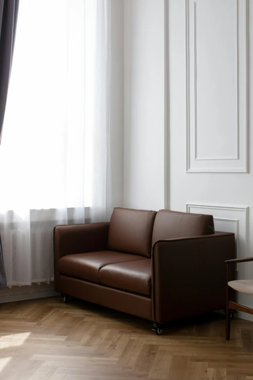 a leather couch sitting in the corner of a living room