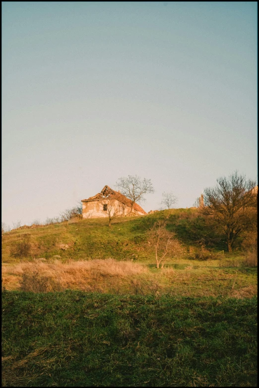 a house on top of a hill with grass