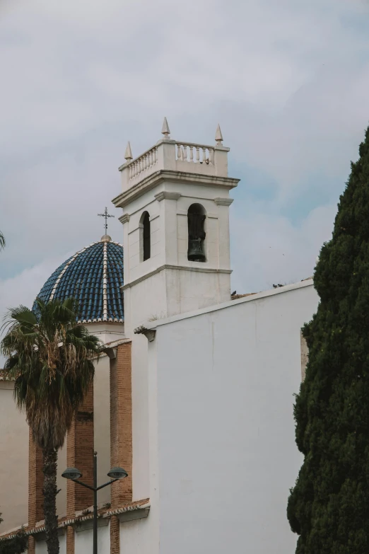 a white building that has a domed roof with two blue domes