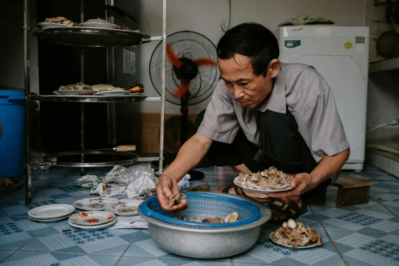 an image of man cooking on a kitchen floor