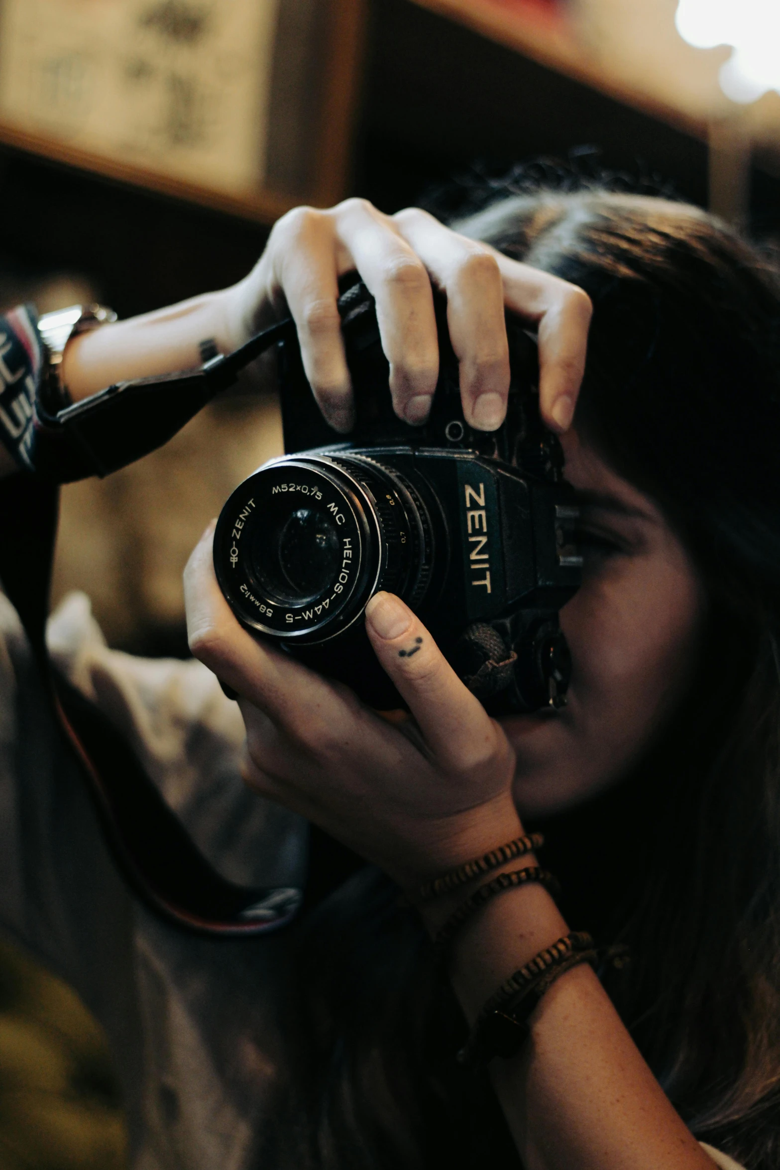 a woman holding a camera up to her face