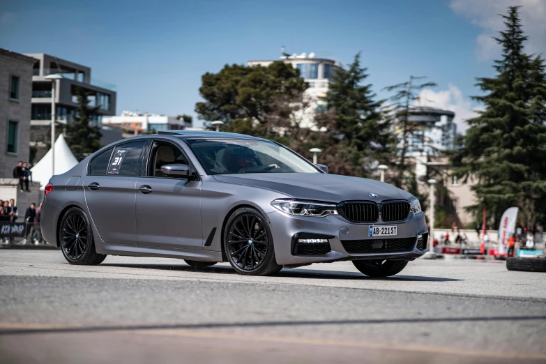 a silver bmw vehicle parked in front of a parking lot