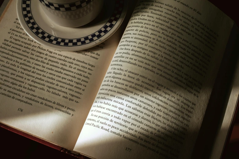 a book opened to show an image of a coffee cup