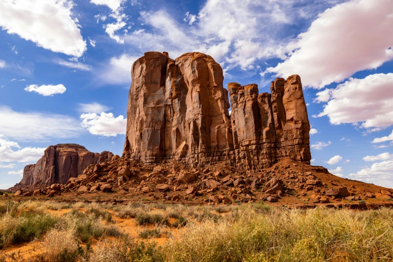 an arid landscape with tall rocks and grass