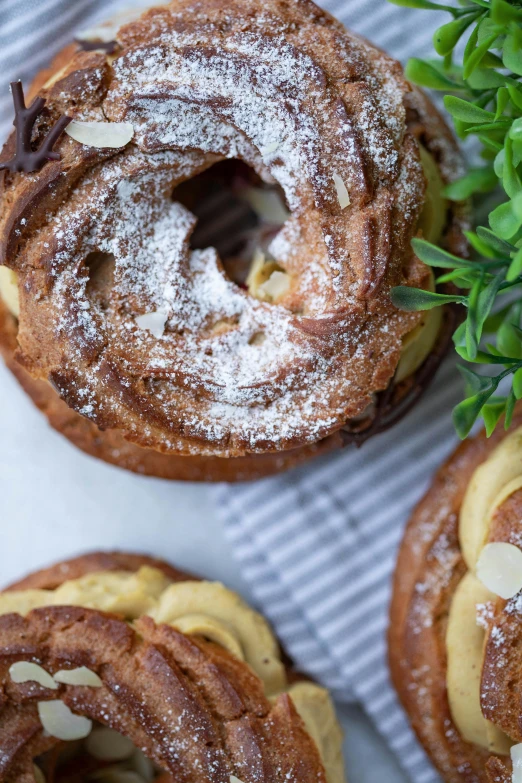 powdered sugar and almond pastries are sitting on the table