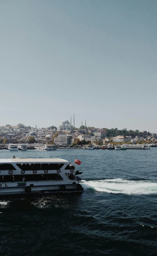 large boat with smaller motorboat speeding in water