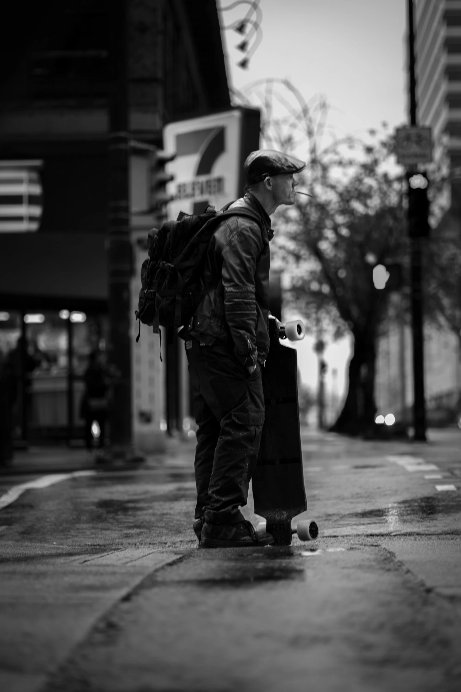 black and white po of young man with skateboard