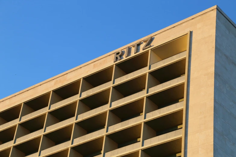 a building with several openings on the outside side and the words sky in a small font on it