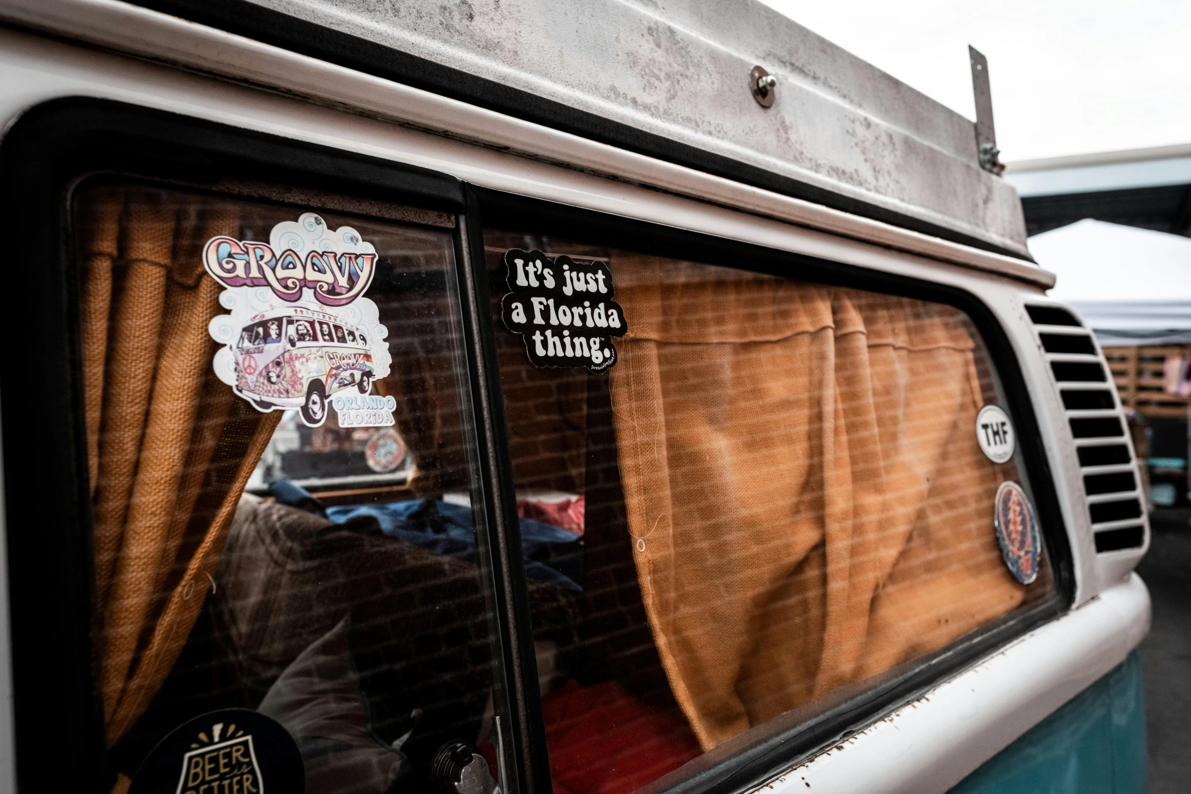 a view of the window on an old bus with various stickers all over it