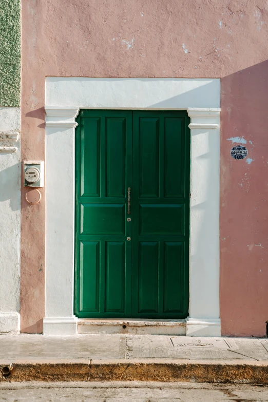 a green and white door and red wall