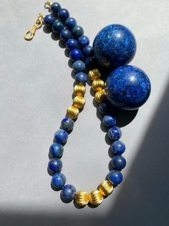 a very nice looking blue and gold necklace on display