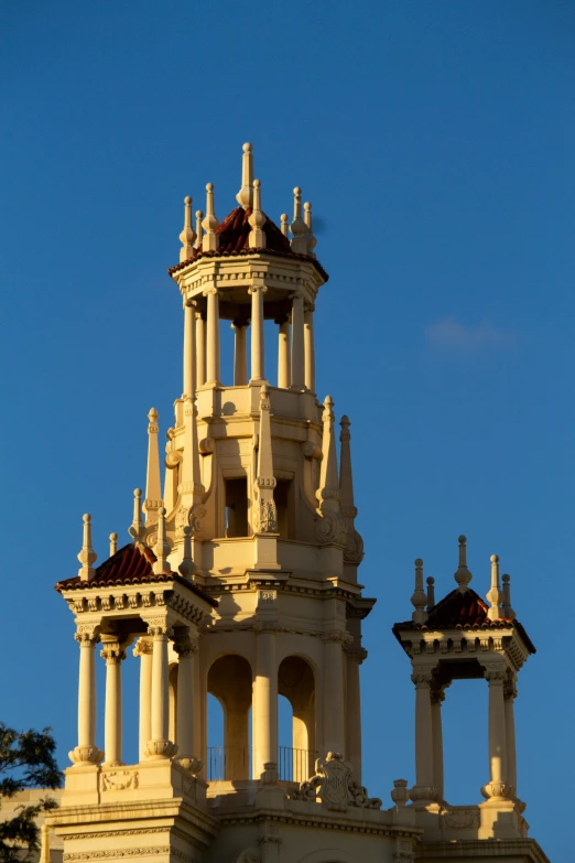 three clocks tower on a building with blue sky in the background