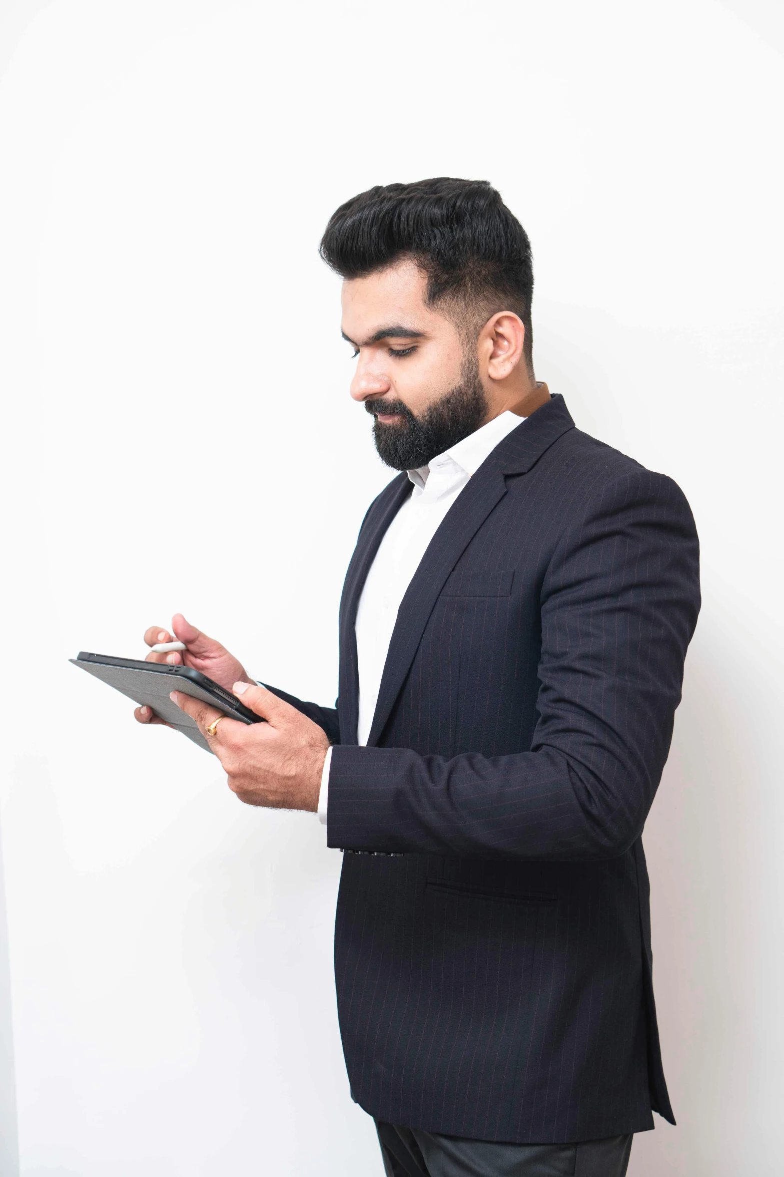 a man in a suit is holding an electronic device
