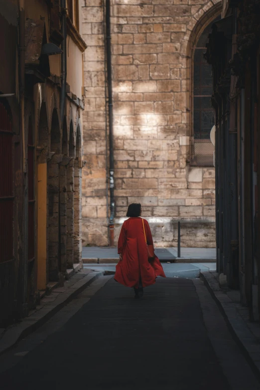 a person in a red coat is walking down a hallway