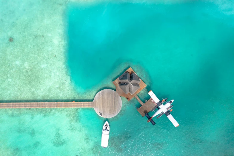 an overhead view of a pier with boats near by