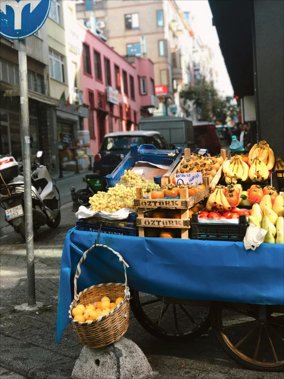 a display on wheels is being loaded with fruit
