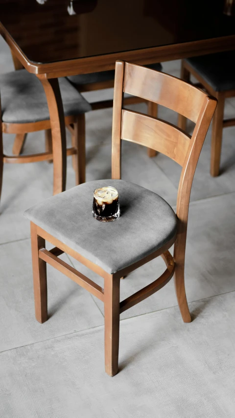 a wooden chair with a cupcake sitting on top