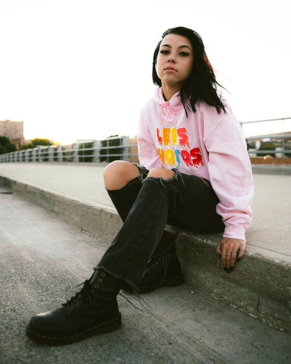 a woman in pink sitting on ledge