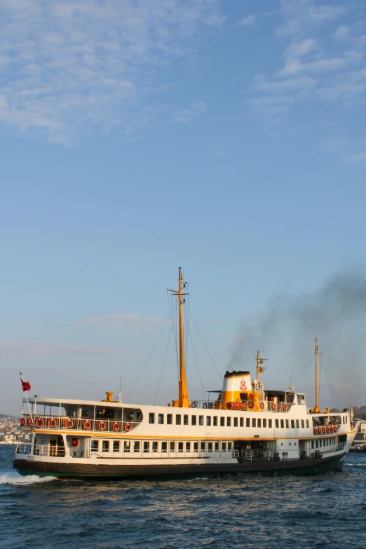 a white ship floating on top of water