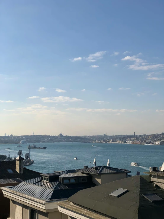 a view of the ocean and sail boats near buildings