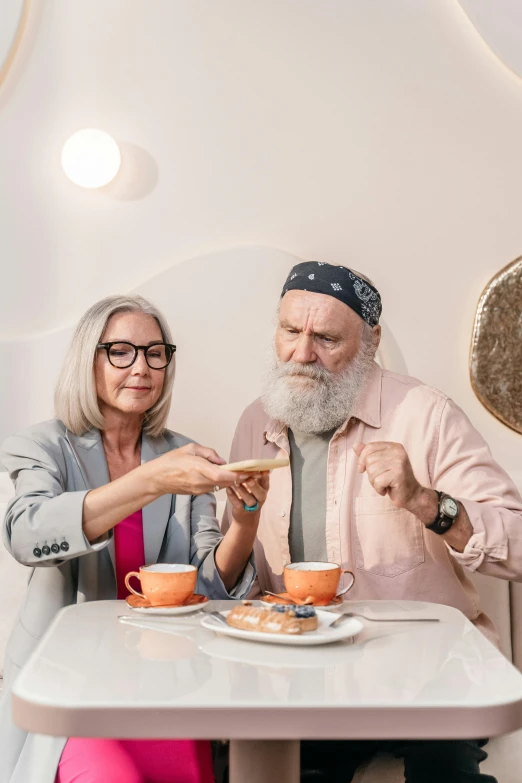 an older couple eating at a table in the kitchen