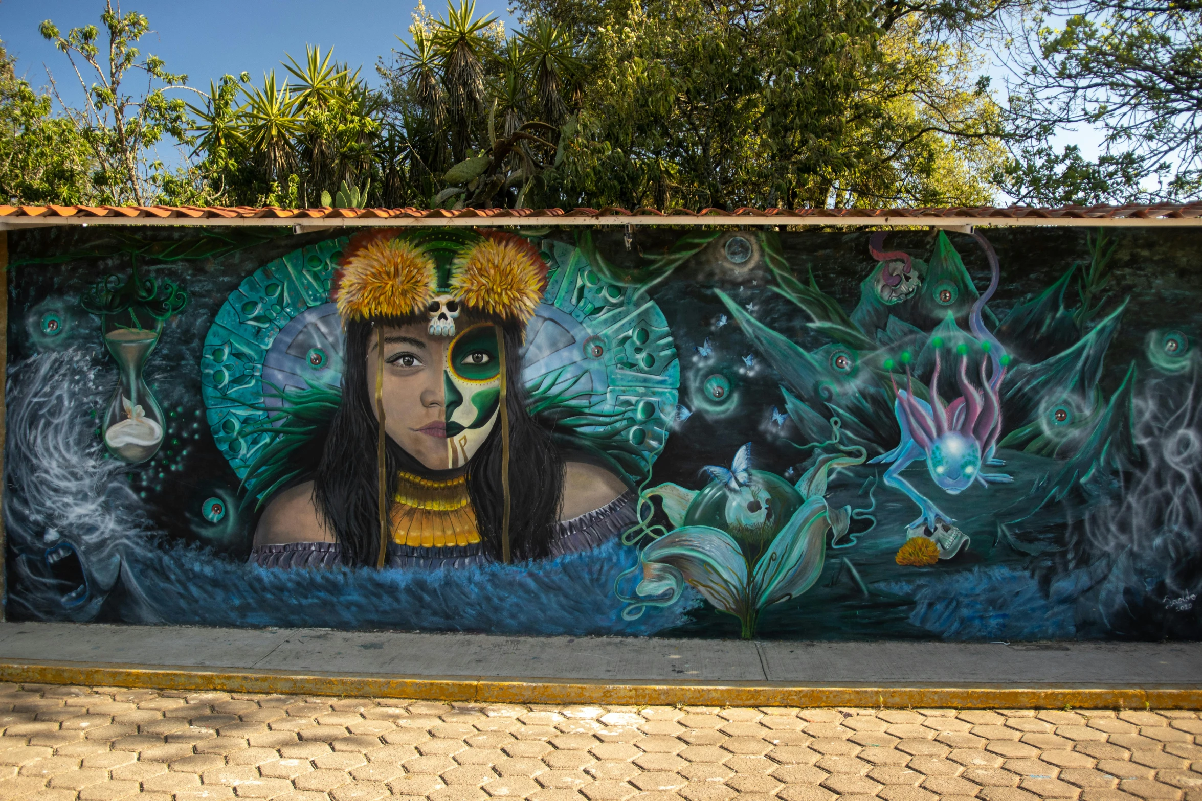 mural featuring native women in native culture behind fence