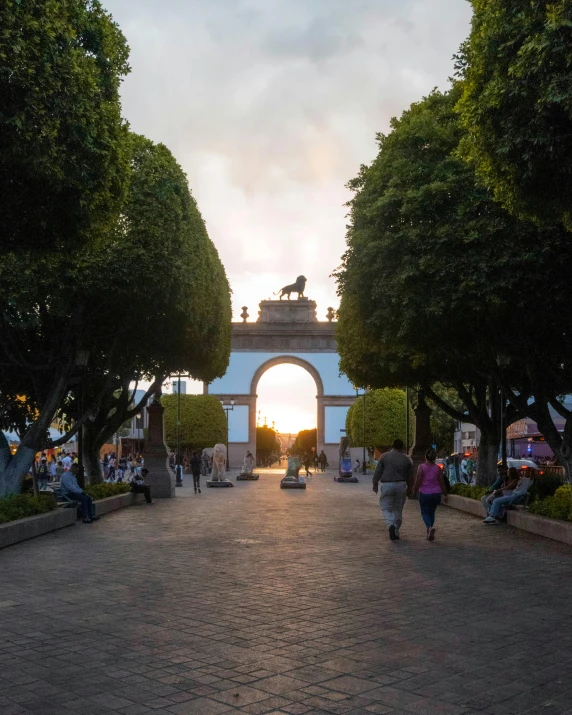 people walk in the park with a arch between them