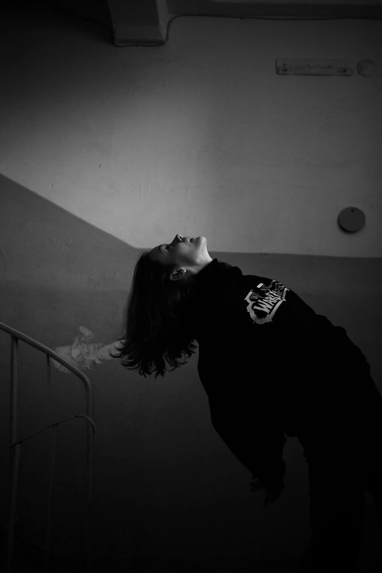 a young woman looks into the sky and reaches down to reach an object