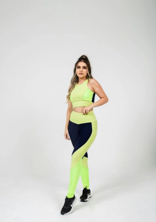 a young woman poses for the camera in a neon green tank top