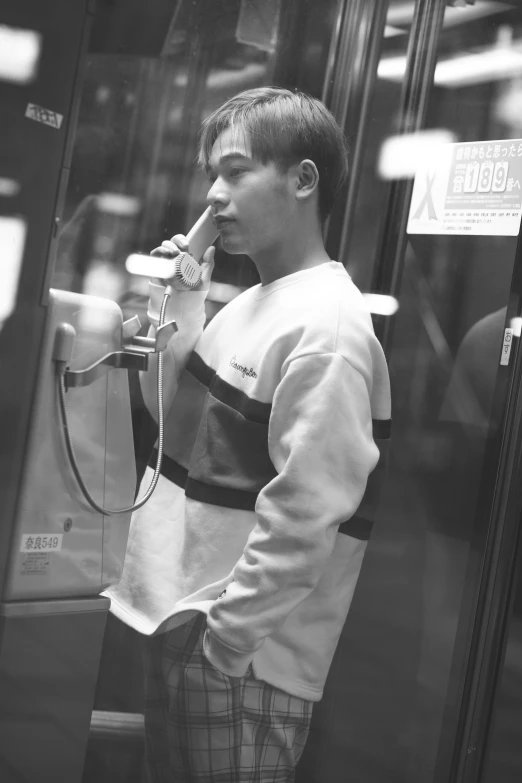 black and white po of a young man in a bus
