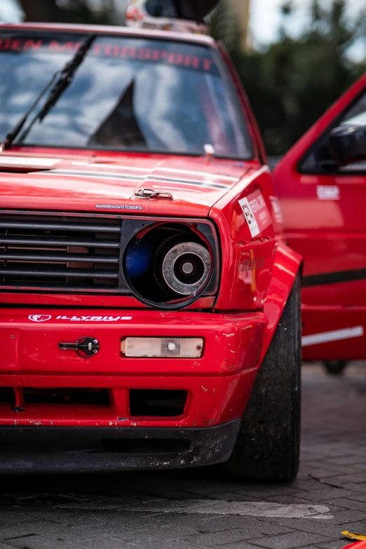 a red car parked next to another red car