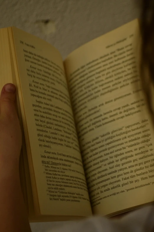 a girl reading a book in her bed