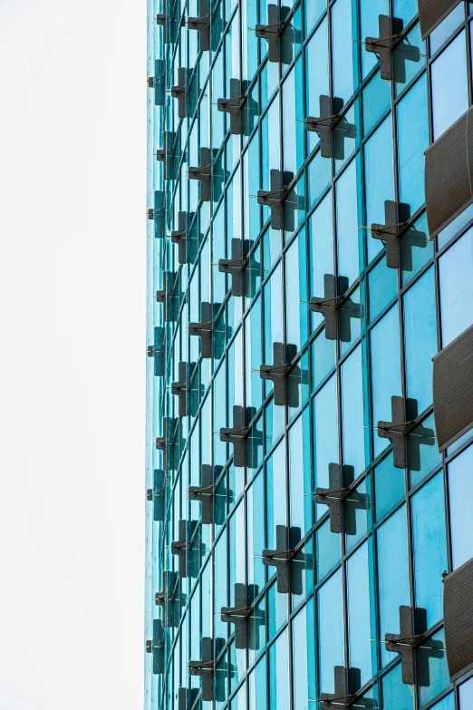 a very tall building with a clock mounted on the side