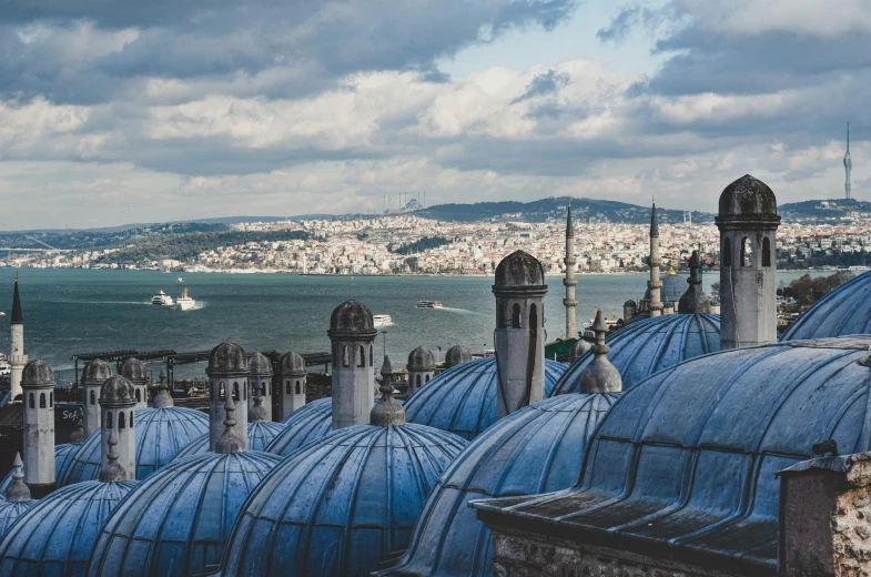 an image of rooftops in europe, looking out at the water