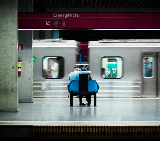 a man sitting on a chair at the subway