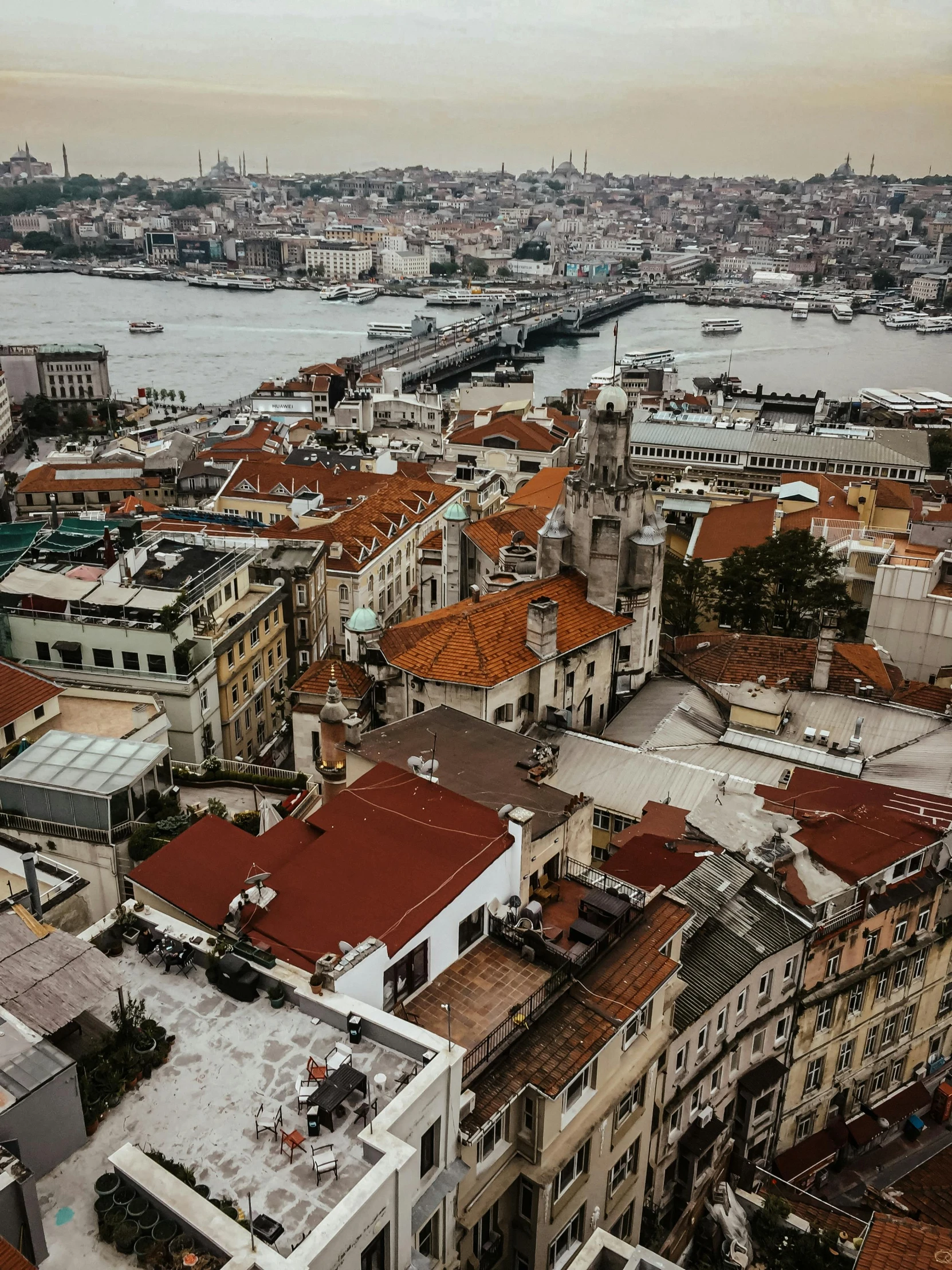 an aerial view of a city with a harbor behind it