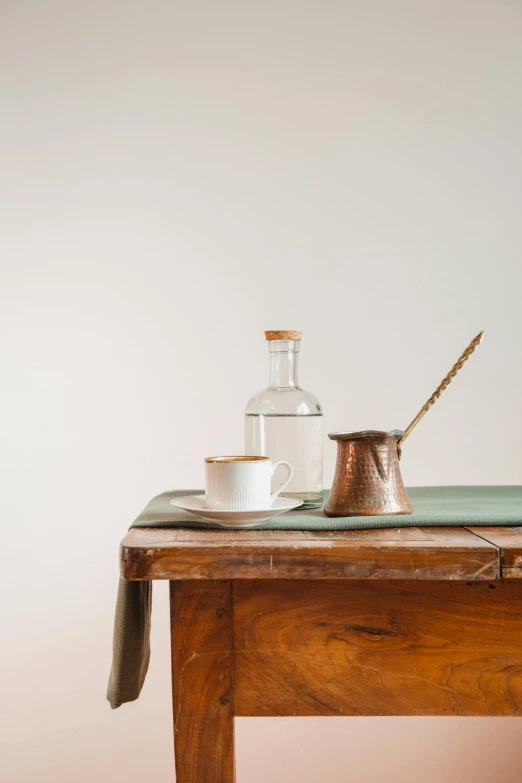 a bottle, salt and pepper shaker on a small table