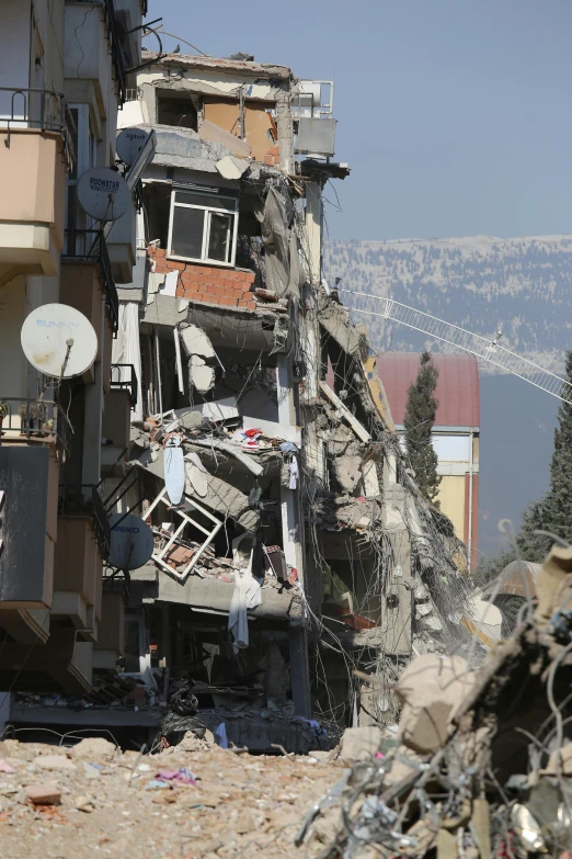 a building surrounded by debris and wire next to trees