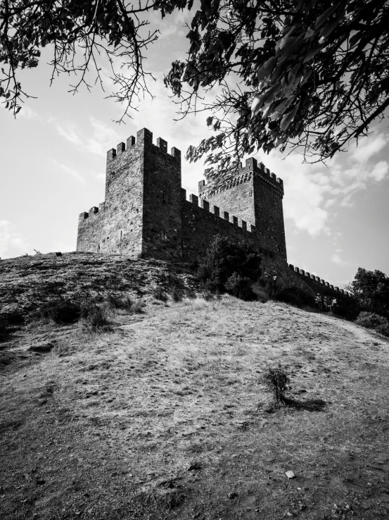 an old stone tower building on top of a hill