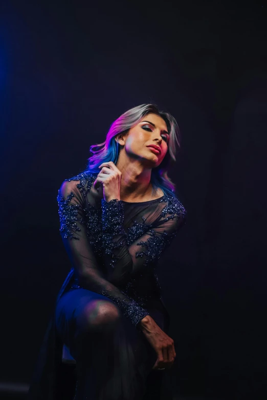 woman with microphone sitting in blue room during nighttime