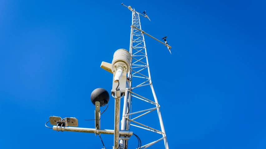 a very tall tower that has some birds on top