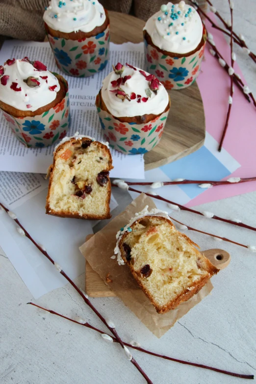 cake sitting on top of a piece of paper next to cup cakes