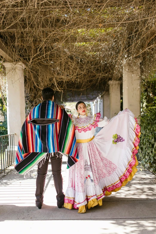 a man wearing a mexican costume with a woman