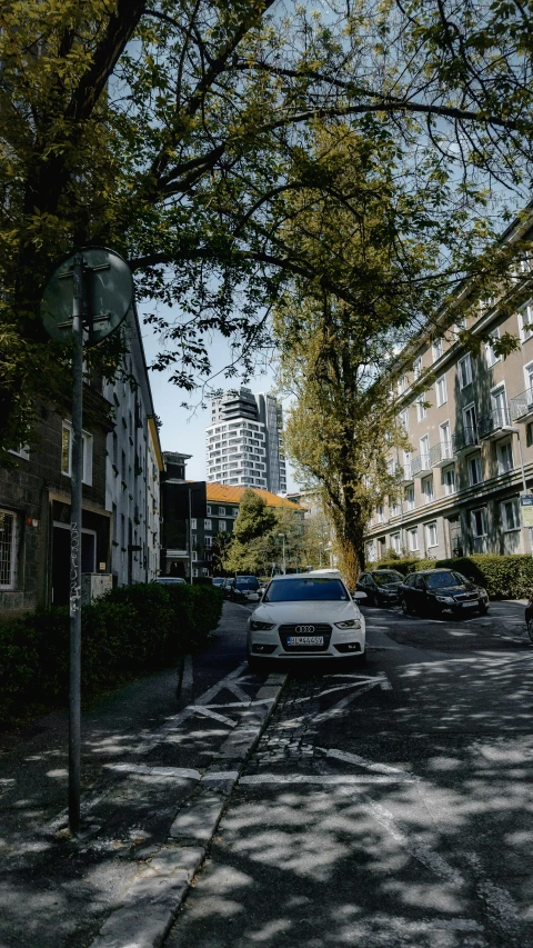 a small road surrounded by buildings next to an intersection