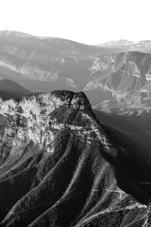 a view of mountains from above, black and white pograph