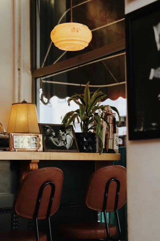 a lamp sits atop a desk with chairs