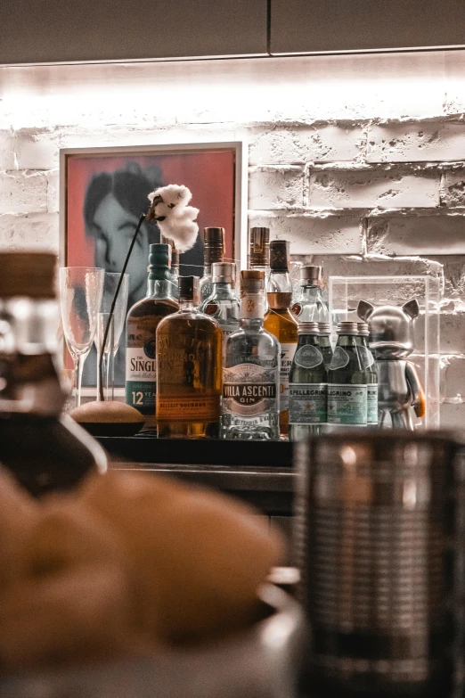 some bottles, glasses and other objects on a counter