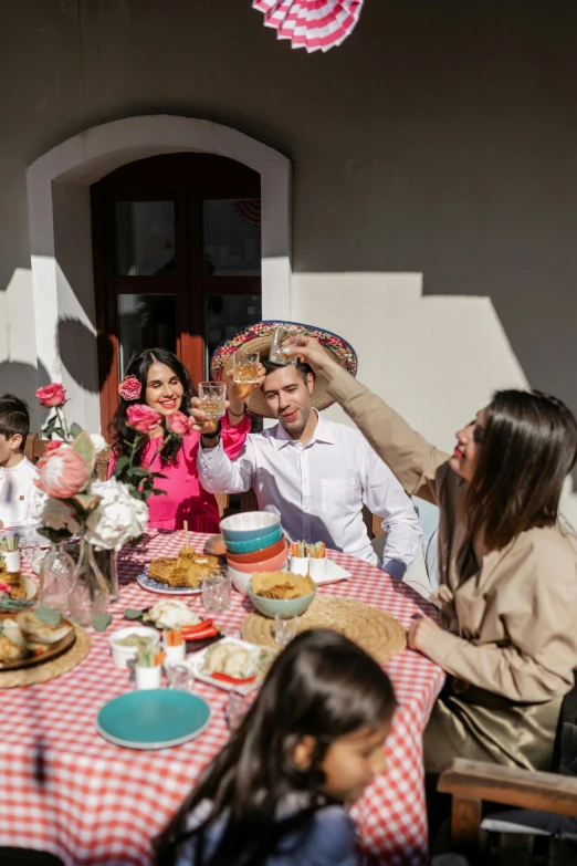 a couple is sitting at the table for an outdoor meal