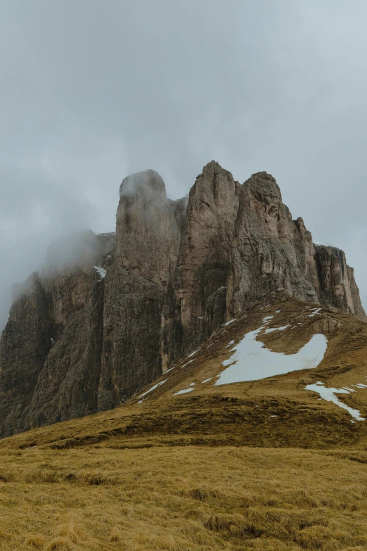 a snowy hill with some tall mountains on one side