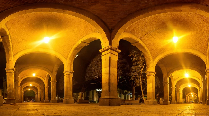 two benches that are in the middle of some pillars